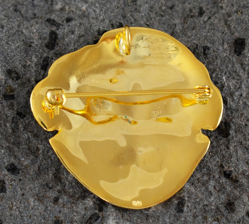 Handcrafted gold plated 925 sterling silver versatile jewel depicting the Mycenaean mask of Agamemnon,the reverse.Museum copy.It can be worn either as a pendant or as a brooch.Its length is 4cm,its width is 4cm and weighs approx. 13g.