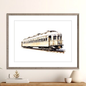 Op de afbeelding: Waterverfschilderij van een vintage treinwagon in crème- en bruintinten, tegen een witte achtergrond. De trein is afgebeeld op rails, omlijst in een grijze houten lijst, klaar om te worden tentoongesteld.