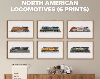 May include: Six framed art prints titled NORTH AMERICAN LOCOMOTIVES (6 PRINTS) featuring detailed illustrations of various diesel trains in orange, blue, red, black, yellow, and green color schemes, displayed in a grid on a light beige wall.