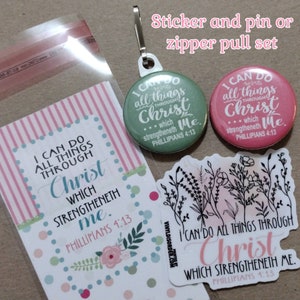 May include: A set of stickers, pins, and a zipper pull featuring the text "I can do all things through Christ which strengtheneth me. Philippians 4:13." The set includes a green pin, a pink pin, and floral stickers.