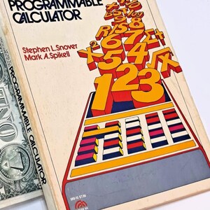 May include: A softcover book titled How to Program Your Programmable Calculator by Stephen L. Snover and Mark A. Spikell. The cover features a graphic illustration of orange numbers and mathematical symbols stacked above a calculator keypad design.