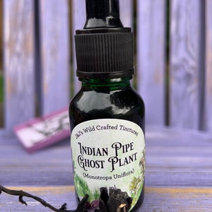 May include: A small glass bottle with a black dropper top and a label that reads "J&J's Wild Crafted Tinctures Indian Pipe Ghost Plant (Monotropa Uniflora)"