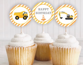 May include: Three yellow and orange construction themed cupcake toppers with a dump truck, excavator, and a traffic cone. The toppers say "Happy Birthday".