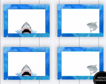 May include: Four rectangular cards with a blue watercolor border and a white interior. Two cards feature a shark with an open mouth, while the other two have a shark illustration. The cards are on a white wooden surface. A black circle with the words "INSTANT DOWNLOAD" is in the bottom right corner.