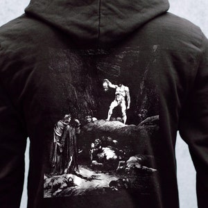 May include: Black hooded sweatshirt with a white graphic print of a scene from Dante's Inferno. The print depicts a man holding a severed head, surrounded by other figures in a dark, cavernous setting.