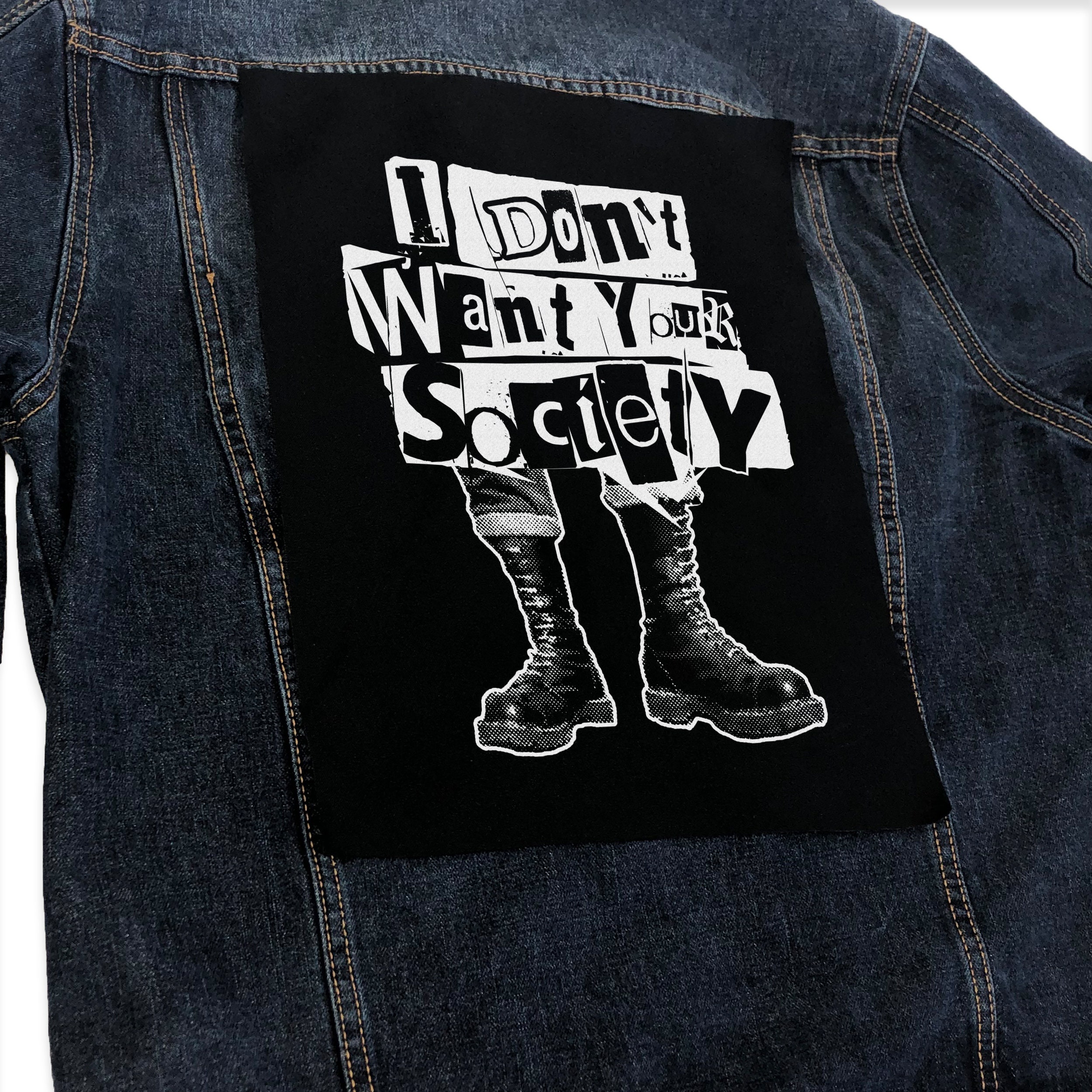 a punk jacket covered in band patches and anarchists