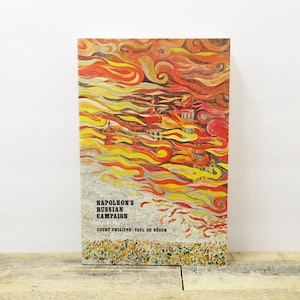 May include: A vintage book cover with an abstract painting of flames and a city skyline. The title of the book is "Napoleon's Russian Campaign" by Count Phillippe Paul de Ségur.