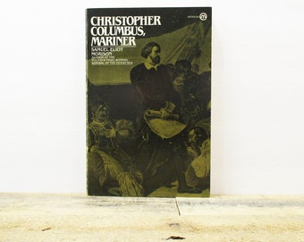 May include: A vintage paperback book titled "Christopher Columbus, Mariner" by Samuel Eliot Morison. The cover features a black and white illustration of Christopher Columbus and his crew on a ship.