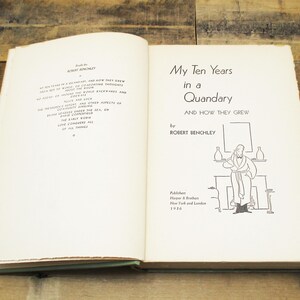 May include: An open book titled "My Ten Years in a Quandary and How They Grew" by Robert Benchley. The book's pages are off-white with black text and illustrations. The cover is a muted green color.