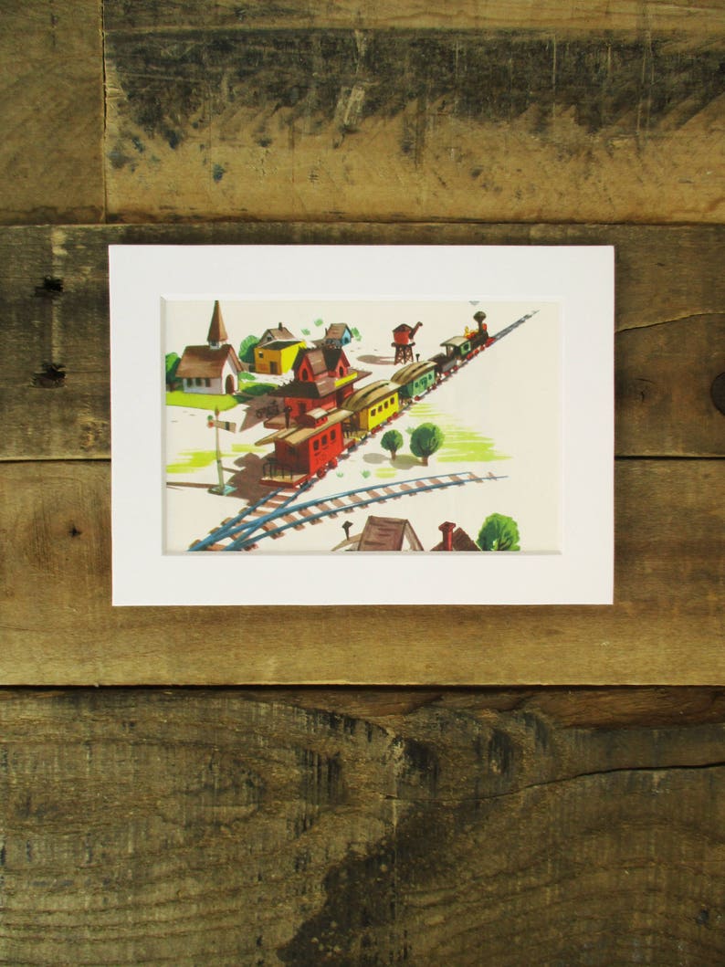 May include: A colorful illustration of a train traveling through a small town. The train is made up of red, green, and yellow cars. The town has a church, houses, and trees.