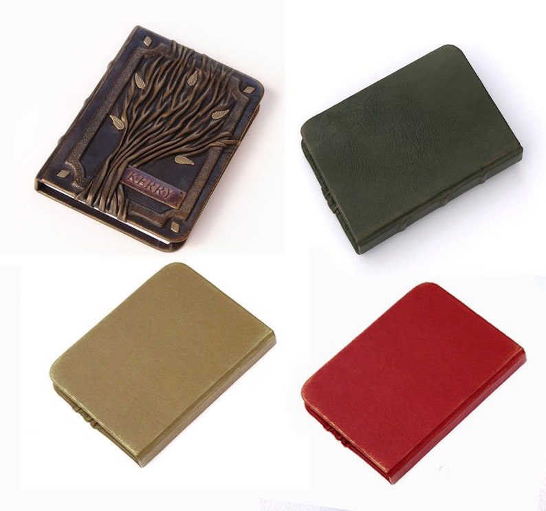 May include: Four rectangular notebooks with rounded corners. One is dark brown with a raised tree relief and the name KERRY embossed on a plaque. The other three are solid, plain covers in matte olive green, muted gold, and bright red colors.