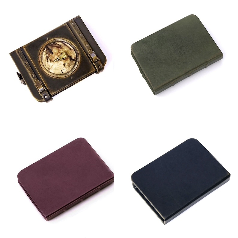 May include: Four small cases, including a vintage-style box with a wolf emblem and three others in dark green, burgundy, and navy blue. The cases are made of a leather-like material and are displayed on a white background.