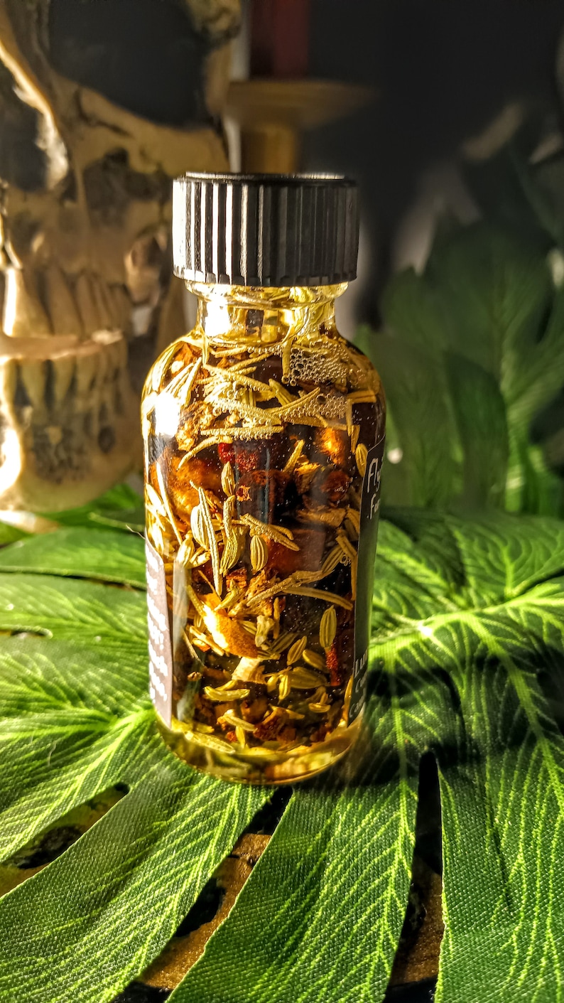 May include: A small glass bottle filled with a clear liquid and various herbs and spices. The bottle has a black screw-top lid and a label that reads "Fly High" and "For the Soul".