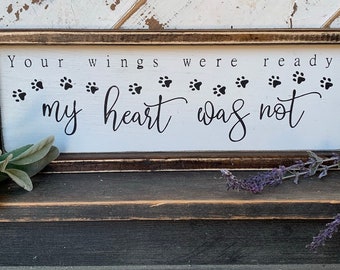 May include: A white wooden sign with black text and paw prints that reads "Your wings were ready my heart was not".