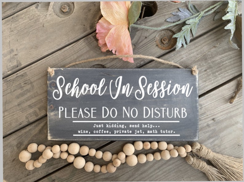 May include: A black wooden sign with white text that reads "School In Session PLEASE DO NO DISTURB Just kidding, send help... wine, coffee, private jet, math tutor."