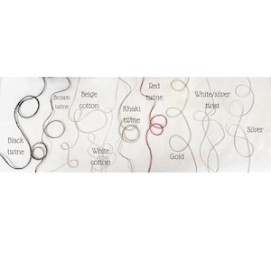 May include: A collection of twines and cotton threads in various colors, including black, brown, beige, white, khaki, red, gold, silver, and white/silver twist. Each thread is labeled with its color name.