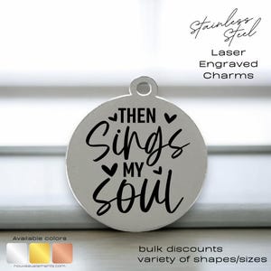 May include: A silver charm with the text "THEN Sings MY Soul" engraved on it. The charm is round and has a small loop at the top for attaching to a necklace or bracelet.
