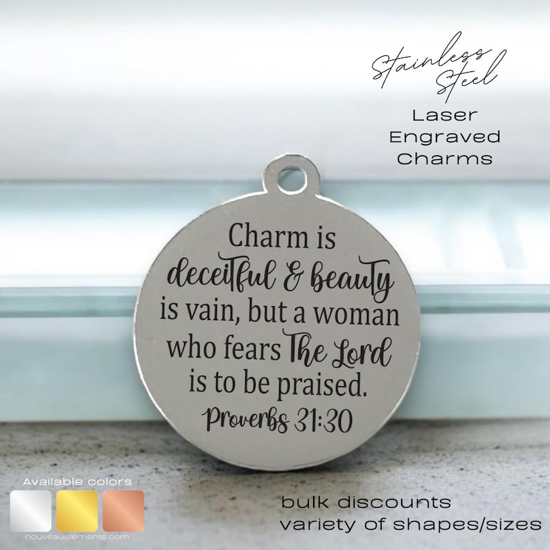 May include: A silver charm with the text "Charm is deceitful & beauty is vain, but a woman who fears The Lord is to be praised. Proverbs 31:30" engraved on it.
