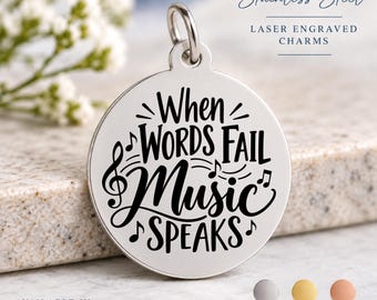 May include: A round stainless steel charm featuring the laser-engraved text When Words Fail Music Speaks, accompanied by musical note symbols. The charm includes a top loop for attachment and is shown alongside color options for silver, gold, and rose.