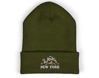 May include: Olive green beanie with the text "Western New York" in white script and a stylized outline of New York State. The hat is made of a soft, knitted material.