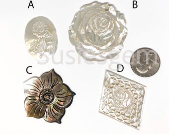 May include: Four mother-of-pearl pendants in various floral designs. Includes an oval sunflower pendant, a rose pendant, a flower pendant, and a square pendant with a rose design. A US dime is included for size reference.