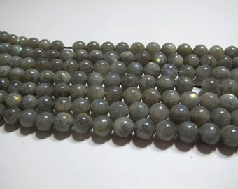 May include: A strand of round, gray labradorite beads. The beads have a slight iridescent sheen.