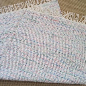 Woven rag rug,  red, white, blue and green.  Measures 25 by 52 inches.  Shipping incl.  JW79