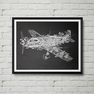 May include: A framed print featuring a detailed white blueprint of a vintage airplane against a black background. The cutaway view reveals the internal structure of the aircraft, including the engine and cockpit. The print is encased in a black frame.