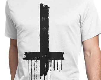 May include: A white t-shirt with a black upside-down cross printed on the front. The cross is painted in a dripping style, giving it a grunge aesthetic.