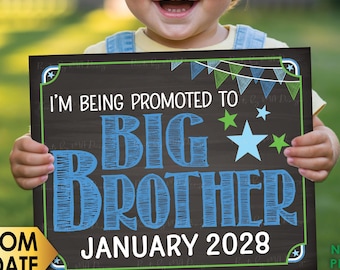 May include: A rectangular digital print sign with a dark brown wood grain background featuring the text I'M BEING PROMOTED TO BIG BROTHER JANUARY 2028 in blue and white, accented with green and blue stars and a bunting banner at the top.