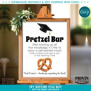 May include: A wooden easel displays a graduation-themed sign that reads "Pretzel Bar." The sign features a black graduation cap, a pretzel graphic, and text inviting guests to enjoy a snack. The sign is decorated with greenery and a "Made with Corjl" logo.