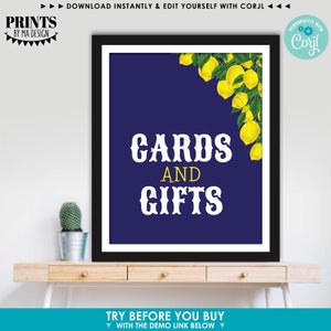 May include: A printable sign with a navy blue background and a white border. The sign has a lemon illustration in the top right corner and the text "CARDS AND GIFTS" in white letters.