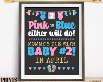 May include: A framed digital print with a black background, featuring pink and blue text that reads "Pink or Blue either will do! Mommy's due with Baby #2! in April." The print includes baby-themed graphics and the text "DATED APRIL".