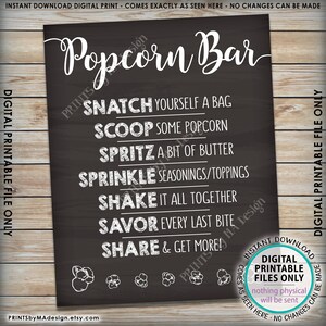 May include: Black chalkboard sign with white text that reads "Popcorn Bar".  The sign has instructions for making popcorn: "Snatch yourself a bag", "Scoop some popcorn", "Spritz a bit of butter", "Sprinkle seasonings/toppings", "Shake it all together", "Savor every last bite", "Share & get more!"