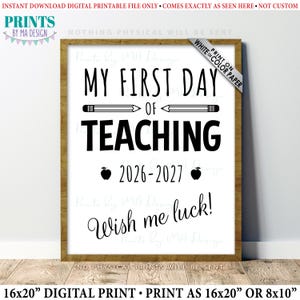 May include: A digital printable sign featuring the black text MY FIRST DAY OF TEACHING, a pencil graphic, the school year 2026-2027 flanked by two apple icons, and the phrase Wish me luck! The design is presented in a wooden frame on a white background.