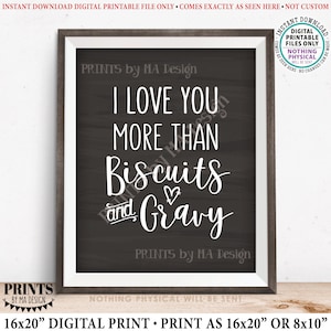 May include: A digital printable sign with a chalkboard background and white text that reads "I love you more than biscuits and gravy". The sign is framed in a brown wood frame.
