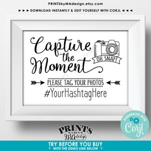 Puede incluir: Se&ntilde;al imprimible en blanco y negro con un gr&aacute;fico de c&aacute;mara y el texto "Capture the Moment" y "Oh Snap!"  Por favor, etiqueta tus fotos #YourHashtagHere.  La se&ntilde;al est&aacute; en un marco blanco.
