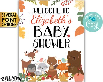 May include: A printable 16x20 inch digital baby shower invitation with a woodland theme. The invitation features a welcome message, the name "Elizabeth's", and the words "Baby Shower". The design includes a variety of woodland animals, including a deer, a raccoon, a squirrel, a fox, and a bear. The invitation is decorated with fall leaves and berries.