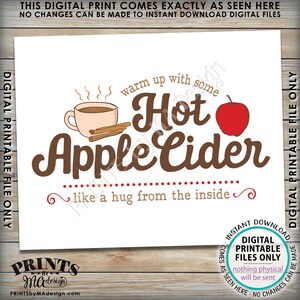 May include: A printable digital design featuring a brown mug with steam coming from it, a red apple, and the text "warm up with some Hot Apple Cider like a hug from the inside".