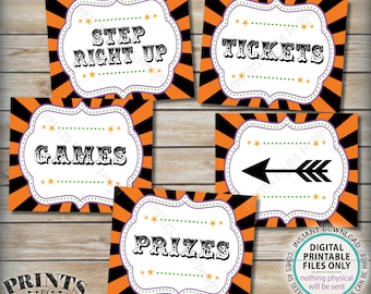 May include: A collection of digital printable signs with a Halloween theme. Each sign features a white, ornate frame with text like "Step Right Up," "Tickets," "Games," "Prizes," and an arrow. The backgrounds are orange and black striped.