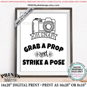 May include: Black and white printable sign with a camera illustration and the text "Oh Snap! Grab a Prop and Strike a Pose".
