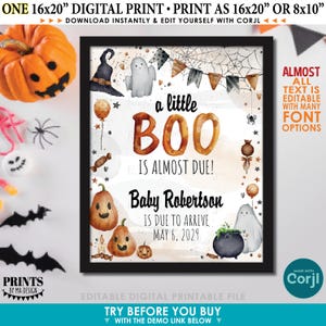 Op de afbeelding: Een ingelijste digitale print met een Halloween-thema. De print bevat de woorden "a little BOO is almost due!" en "Baby Robertson is due to arrive May 6, 2029." Het ontwerp bevat pompoenen, geesten en een heksenhoed.