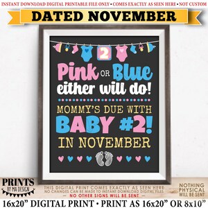 May include: A framed digital print with a black background, featuring pink and blue text that reads "Pink or Blue either will do!" and "Mommy's due with Baby #2! in November." The print includes baby-themed graphics and the text "Dated November."