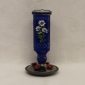 Royal Blue Hummingbird feeder hand painted with white daisies and leaves. 4 feeder ports