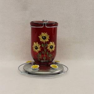 Red glass hummingbird feeder, Hand painted with sunflowers and leaves, 5 feeding ports and a resting pad