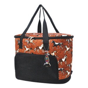 May include: A rectangular cooler bag with a black front pocket and black handles. The bag features a repeating pattern of horses in various colors on a reddish-brown background. A decorative bottle opener hangs from the side.