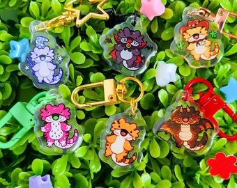 May include: A collection of eight colorful keychains featuring cartoon animal characters. The keychains are made of clear plastic with a variety of colors and designs. The keychains are perfect for adding a touch of personality to your keys or bag.