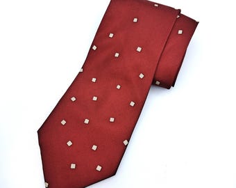 May include: A red tie with a white square pattern.