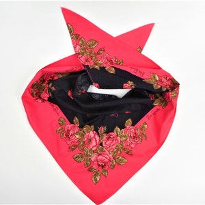 May include: A pink and black bandana with a floral pattern and the text "Paris Boutique" repeated on both sides.