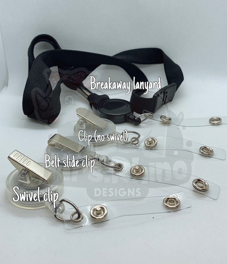 May include: A black breakaway lanyard with a retractable reel and a variety of clips, including a swivel clip, a belt slide clip, and a clip without a swivel. The lanyard is shown with clear plastic badge holders with metal eyelets.